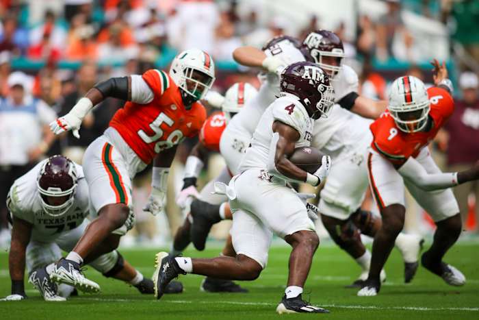 Sep 9, 2023; Miami Gardens, Florida, USA; Texas A&M Aggies running back Amari Daniels (4) runs with the football against the Miami Hurricanes during the first quarter at Hard Rock Stadium. Mandatory Credit: Sam Navarro-USA TODAY Sports